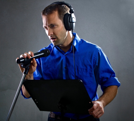 a man wearing headphones and holding a microphone